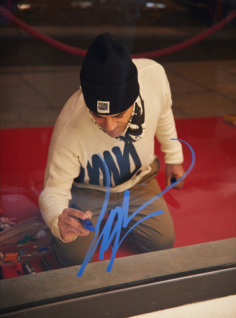 JonOne signing the store window