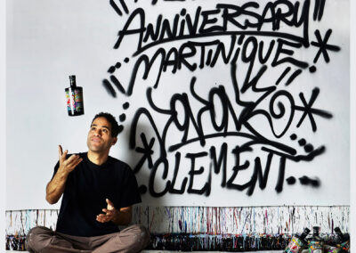 JonOne sitting At The Clement Foundation, playing with a bottle